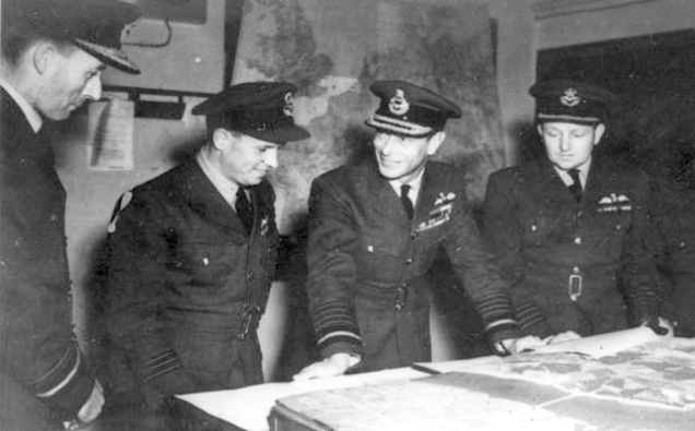 AVM R A Cochrane, Wg Cdr Guy Gibson, King George VI and Gp Capt Whitworth discussing the 'Dambusters Raid' in May 1943